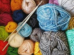 Colorful balls of yarn and knitting needles.