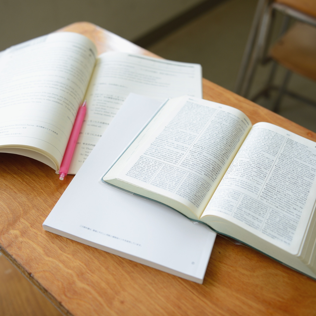 books and notebooks open on a desk
