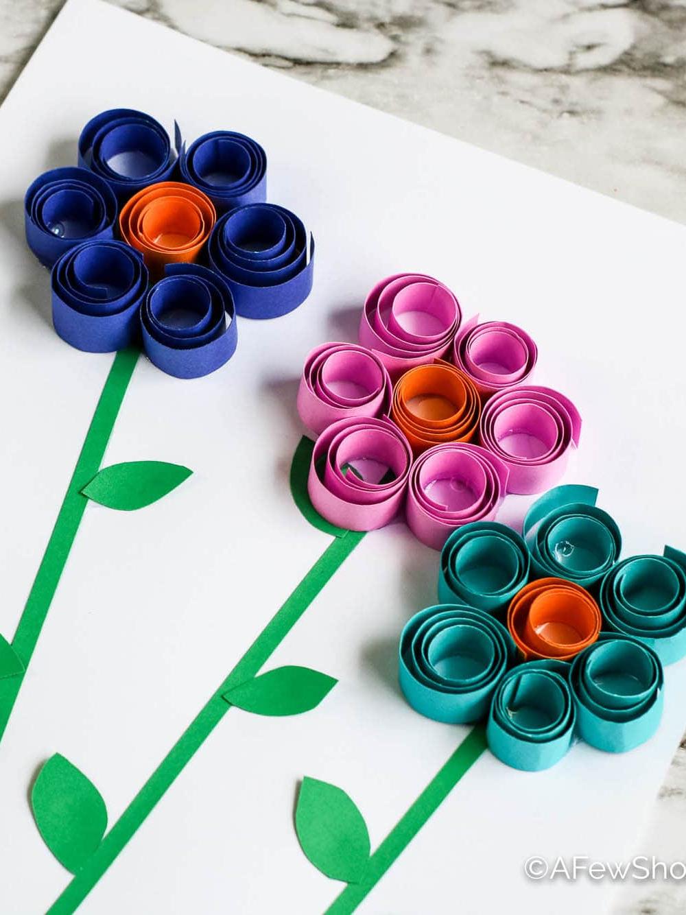 Four quilled paper flowers with stems