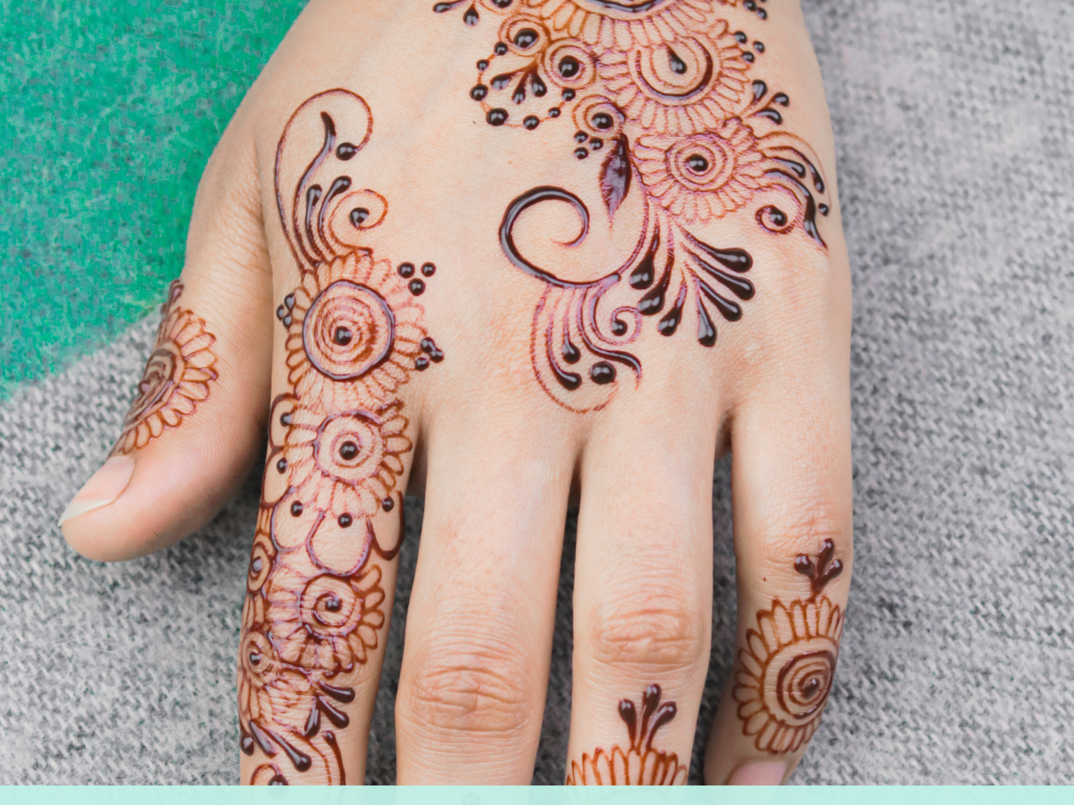 Teen henna flier with henna-tattooed hand