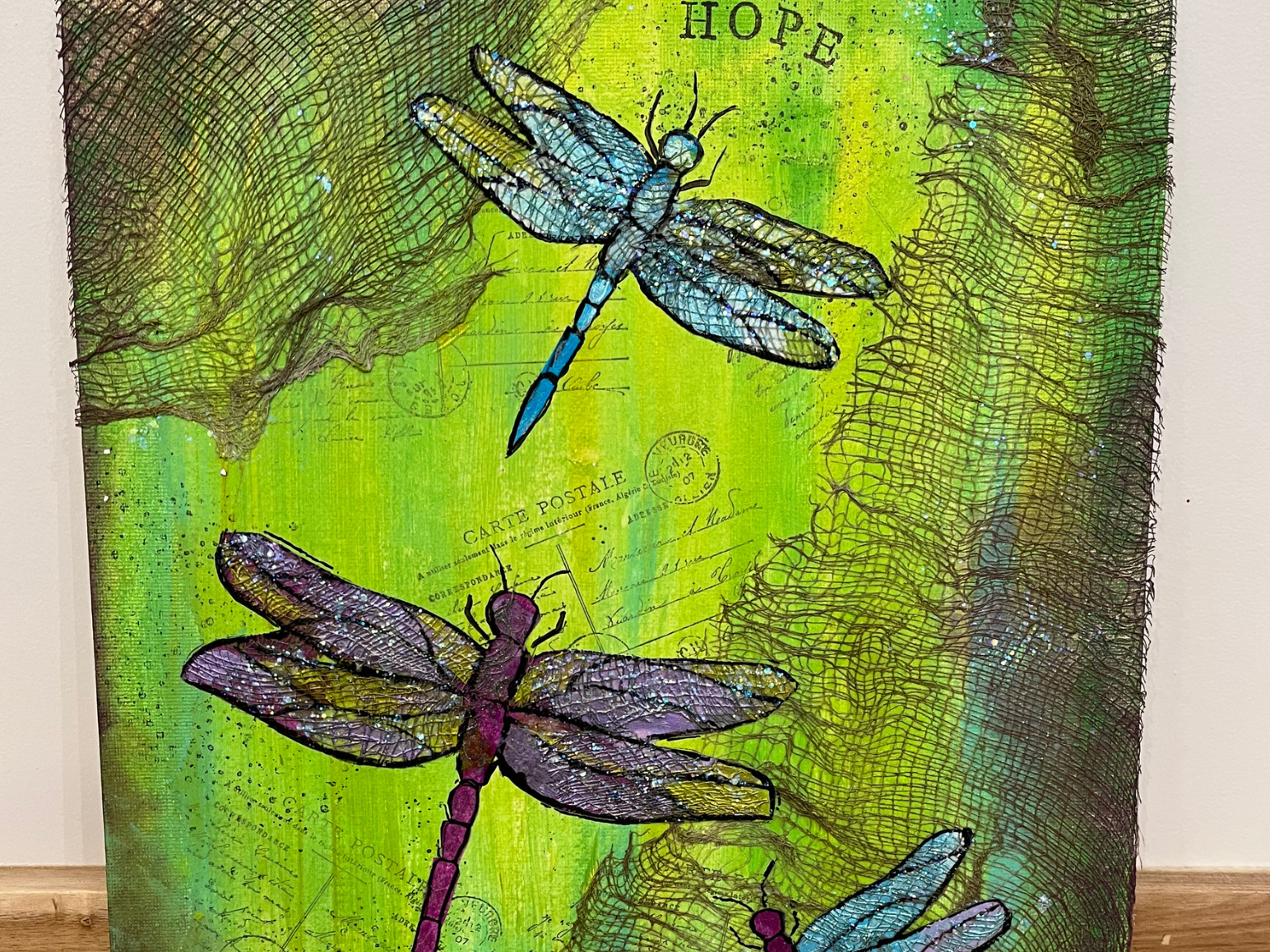 Dragonflies painted on a green background.