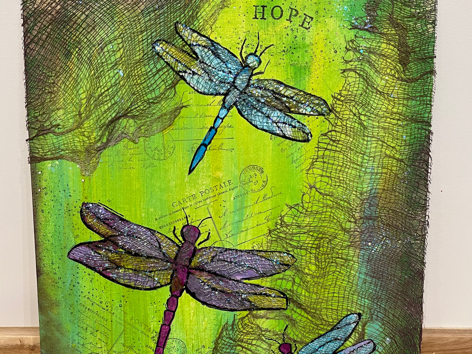 Dragonflies painted on a green background.
