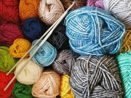 Colorful balls of yarn and knitting needles.