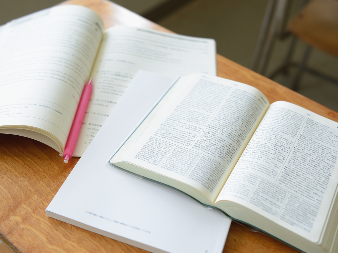 books and notebooks open on a desk